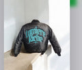 Custom turquoise embroidery on a black satin jacket by Print Collective